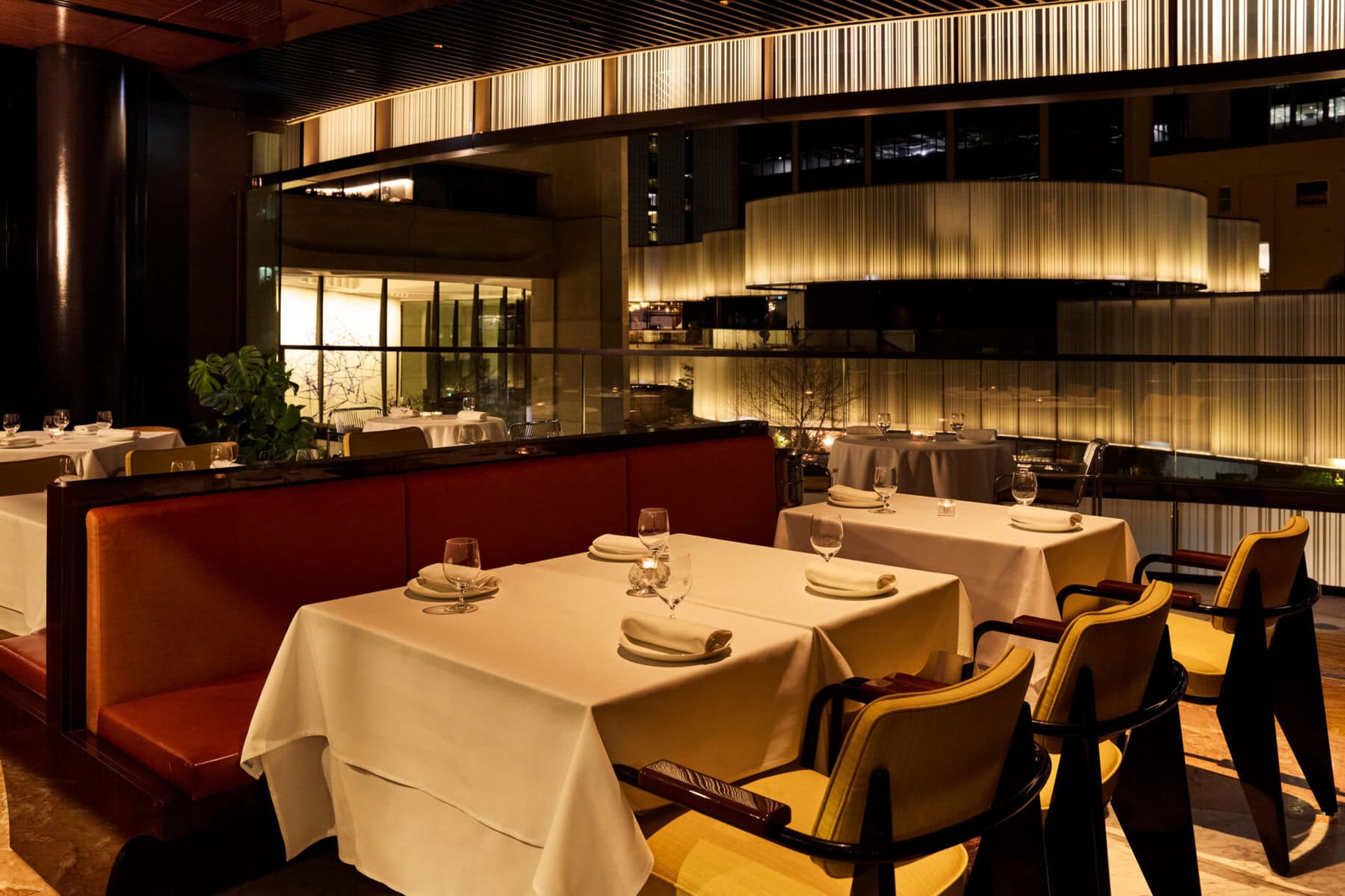 White-clothed tables and open kitchen at The Grill