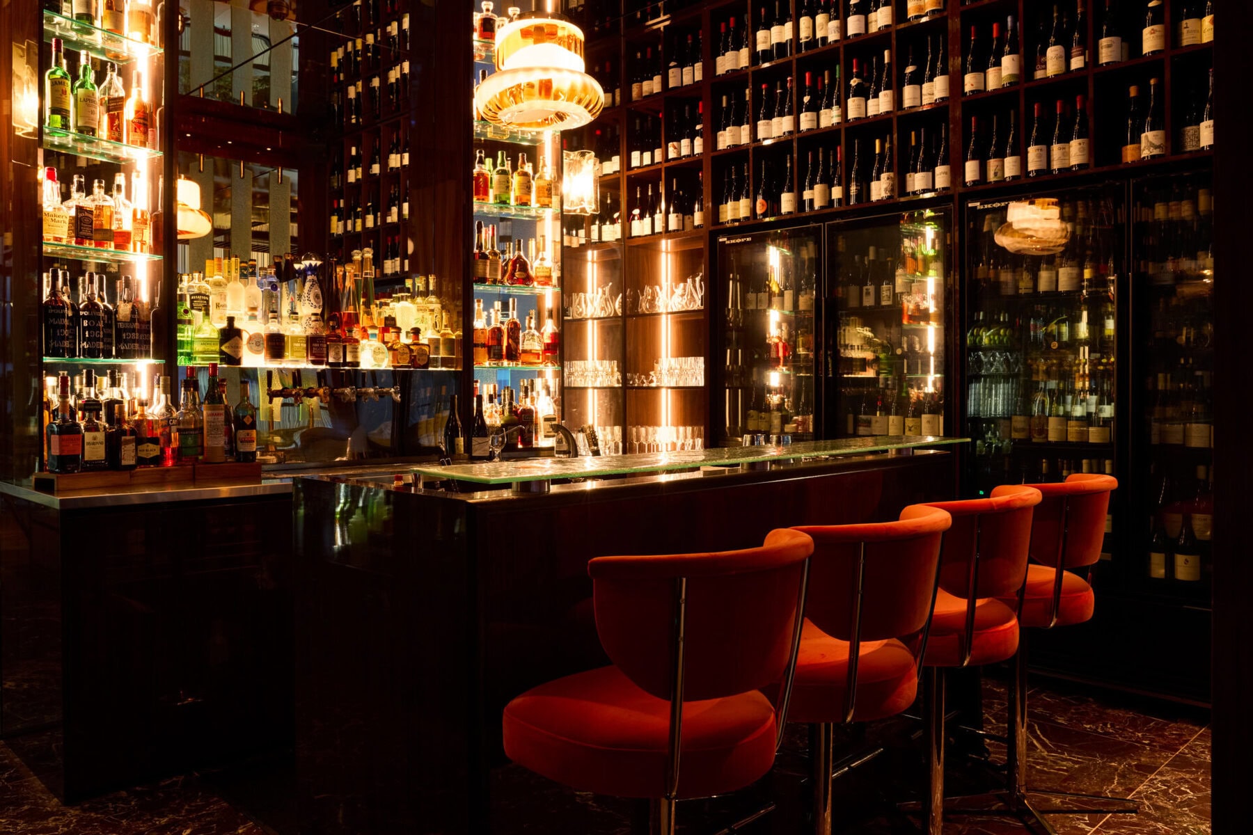 Backlit bar and wine shelves at The Grill